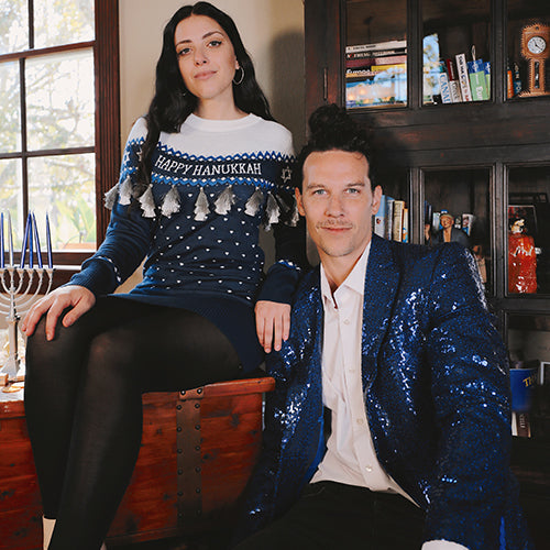 shop hanukkah - models wearing men's blue sequin all over blazer and women's hanukkah tassels sweater dress