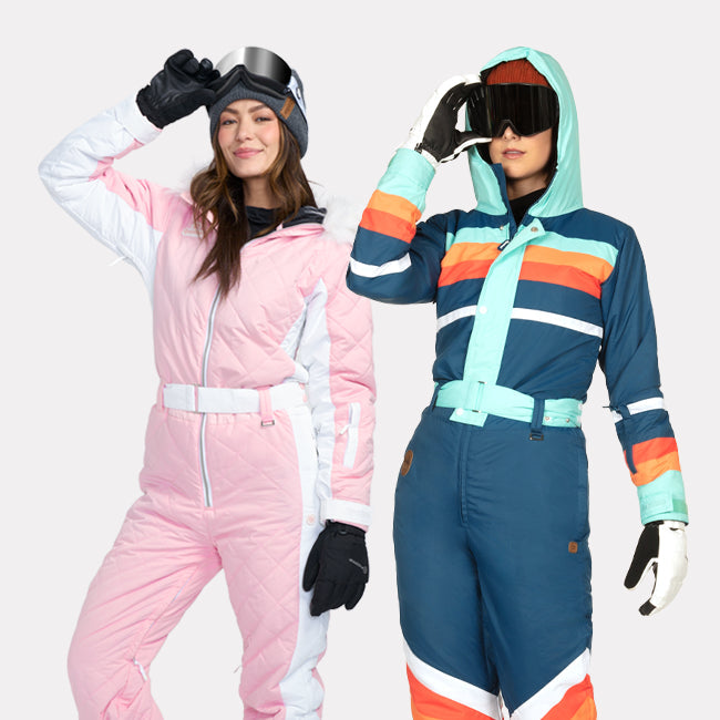 shop snow suits - models wearing women's powder pink snow suit and women's bluebird snow suit