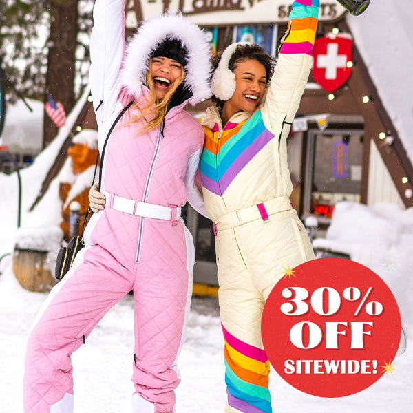 shop women's snow suits - models wearing women's retro rainbow and powder pink snow suits