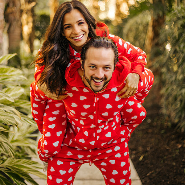 shop valentines clothing - image of man and woman wearing beating hearts jumpsuit